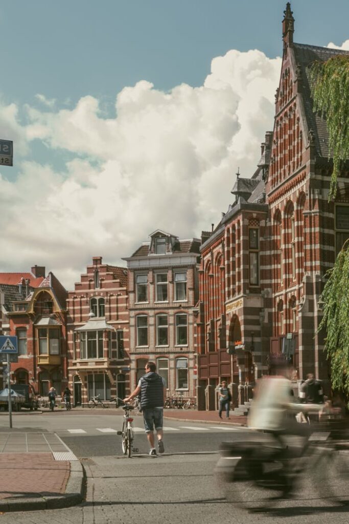 pexels photo 15476390 A lively street scene in Groningen, Netherlands, featuring historic architecture and cyclists.